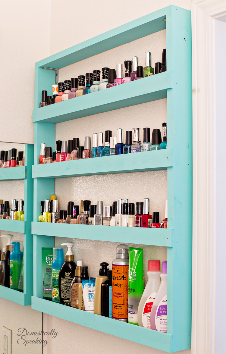 A light blue shelf filled with nail polish and hair products.