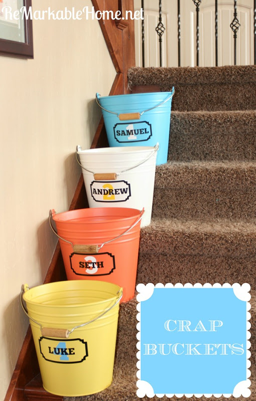 Buckets on stairs that are labelled for toys.