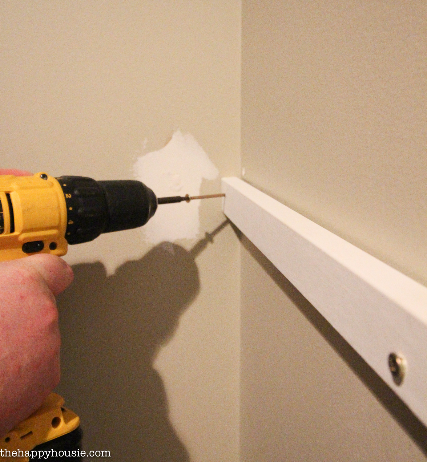 Using the power screwdriver for the shelf.