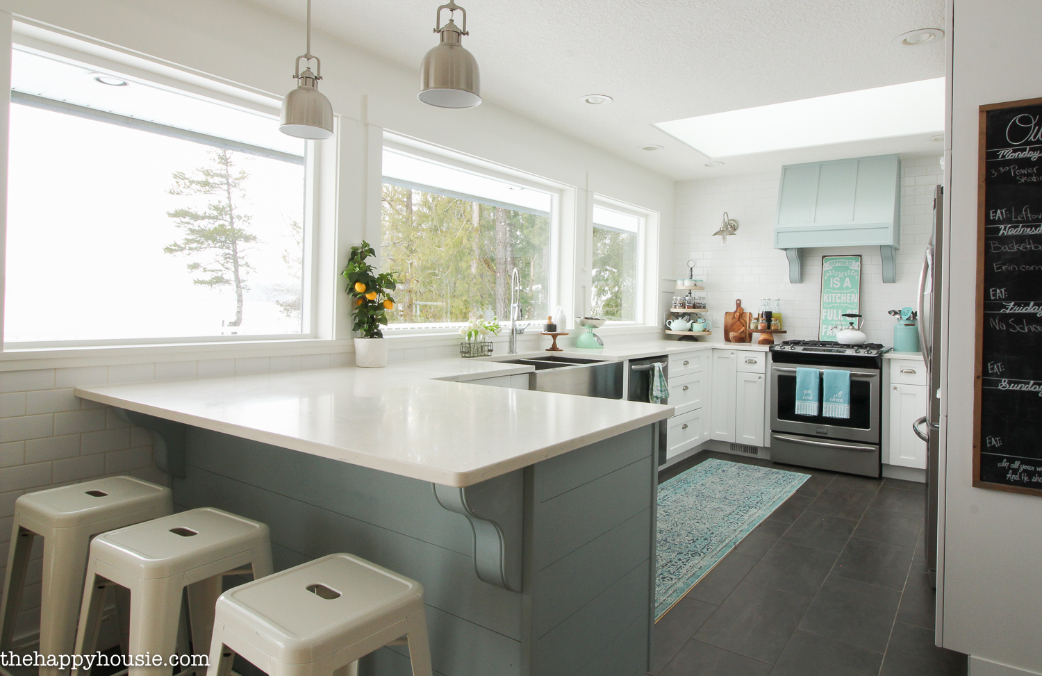 A white kitchen with a blue island.