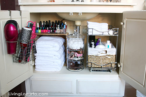 A completely organized bathroom cabinet underneath the sink.