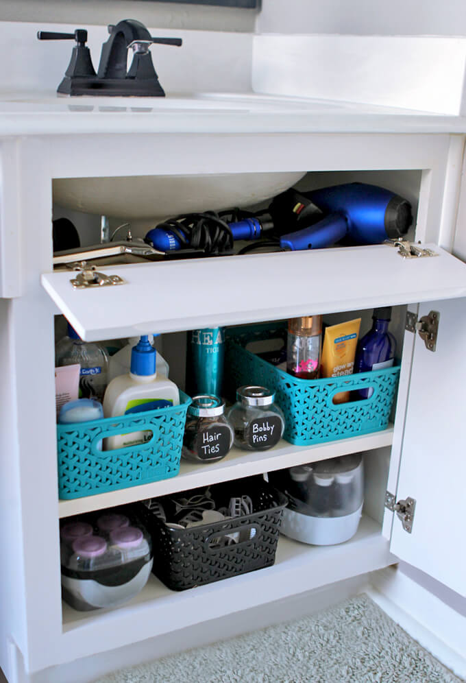 Storage bins under the sink holding hair products and makeup etc.
