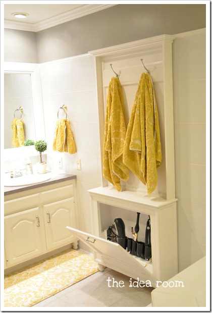 An extra cabinet in the bathroom holding towels and a small storage cupboard.
