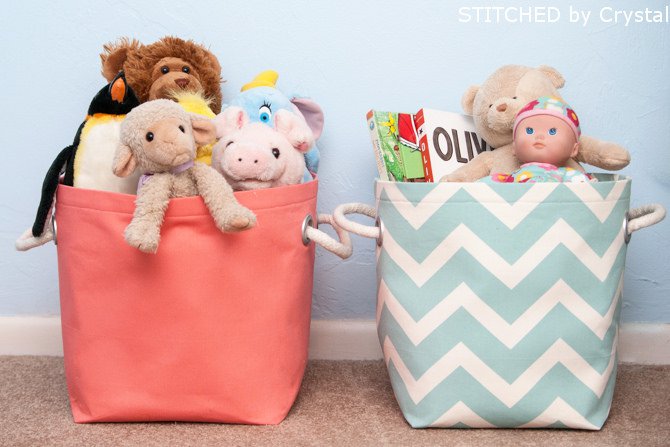 Two baskets with dolls and stuffed animals.