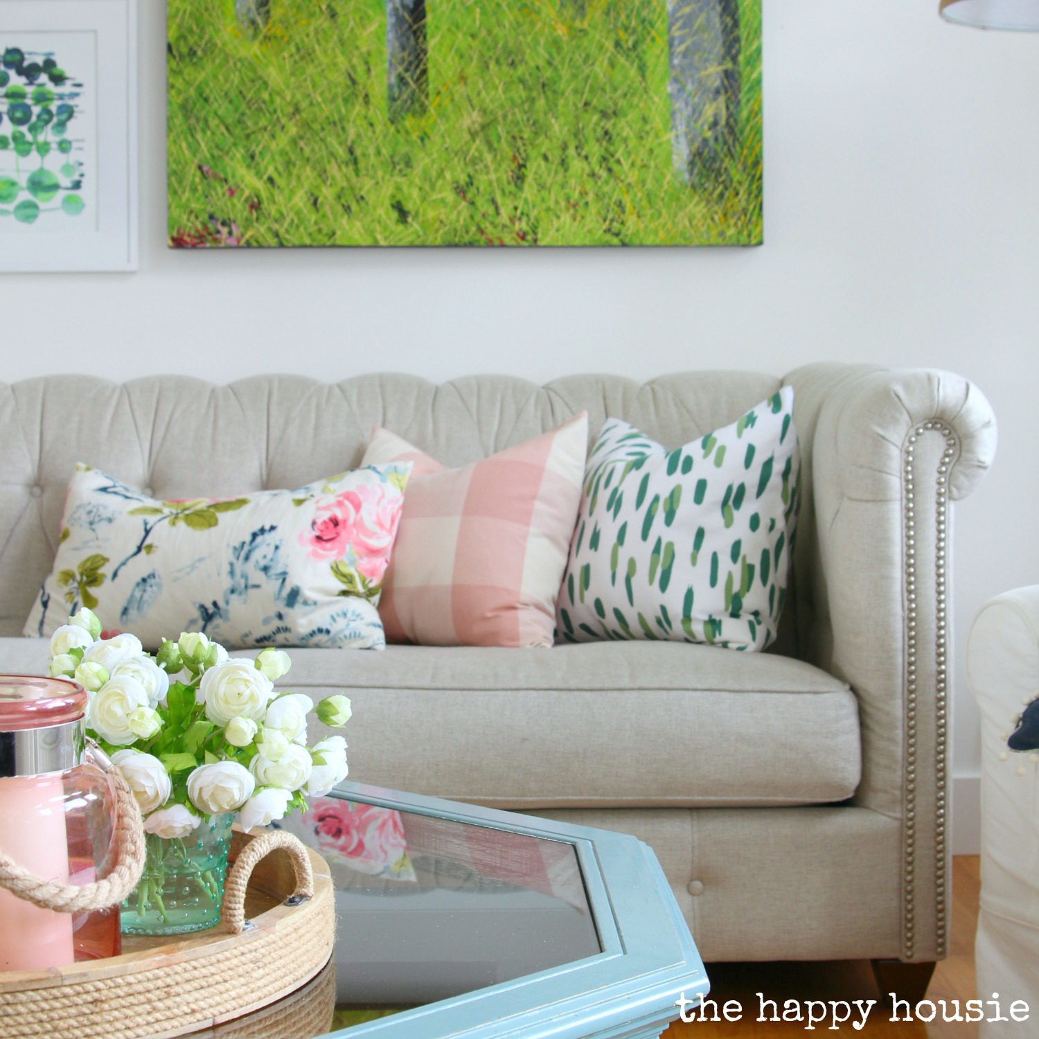 Bright floral and pink pillows on the couch.