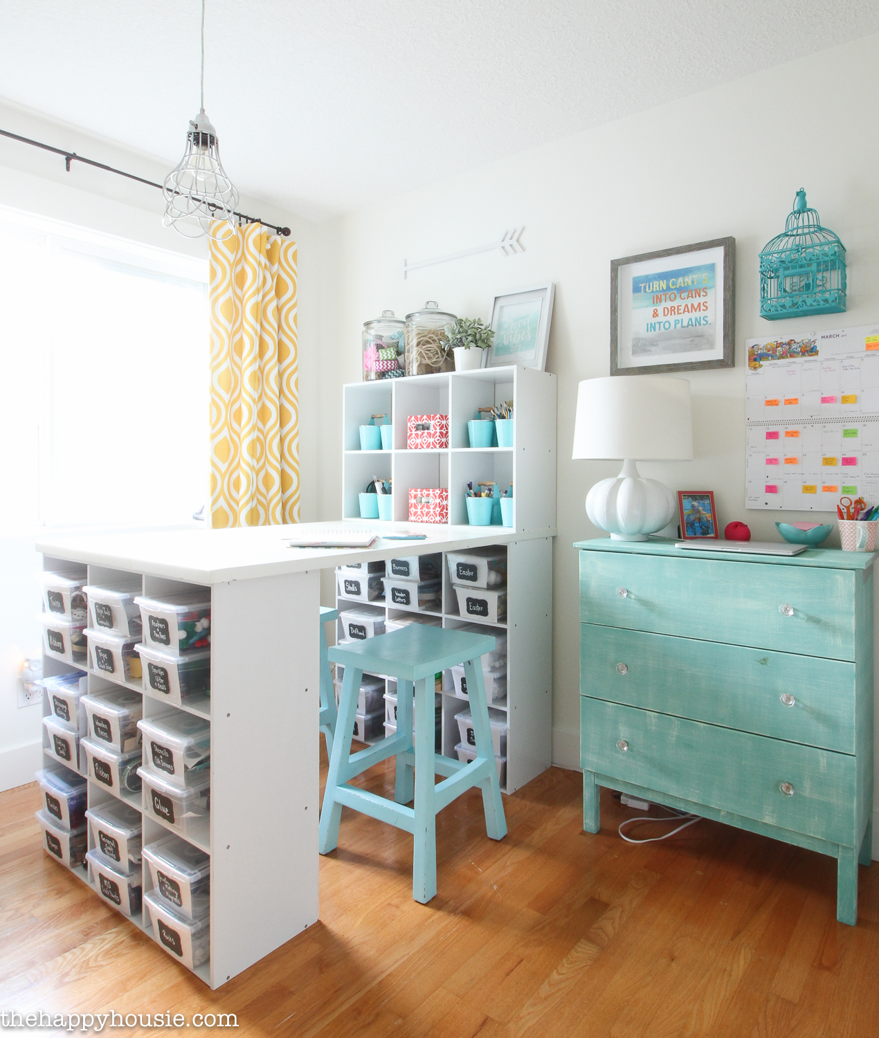 The craft room with a turquoise dresser in it.