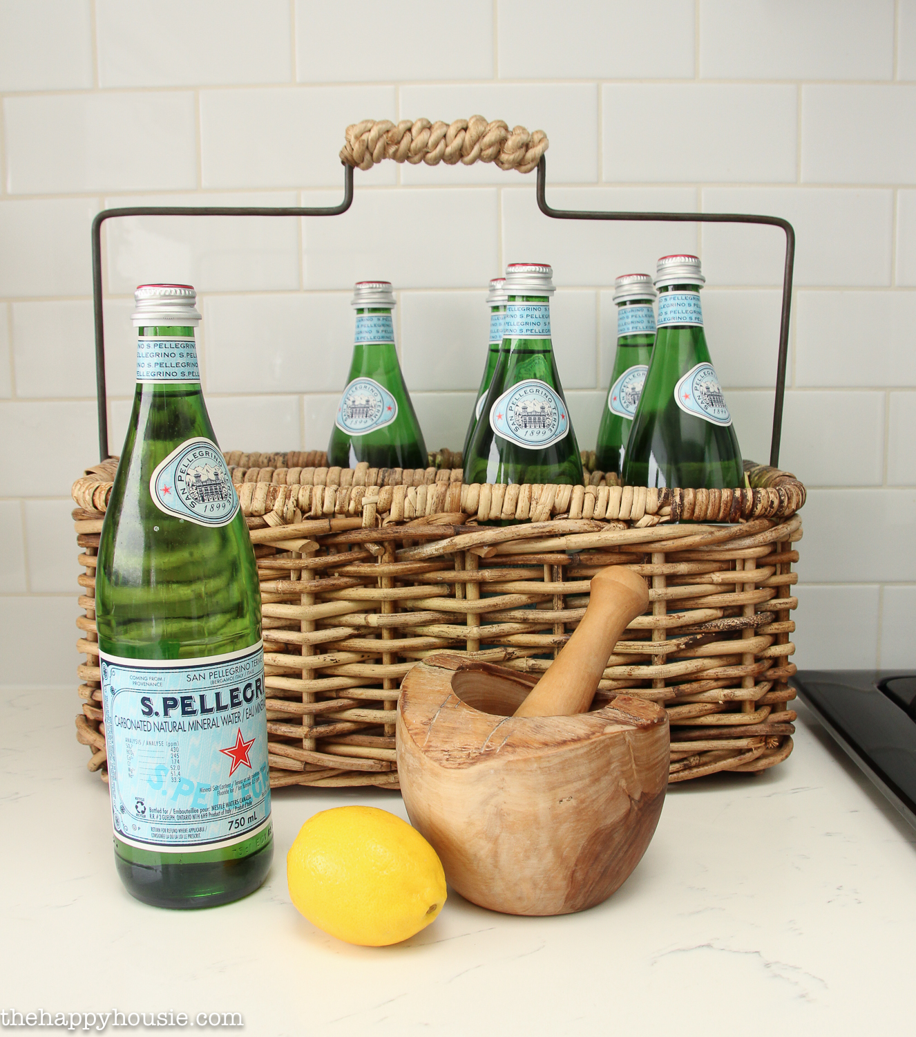 A wicker basket with Pellegrino bottles in it.