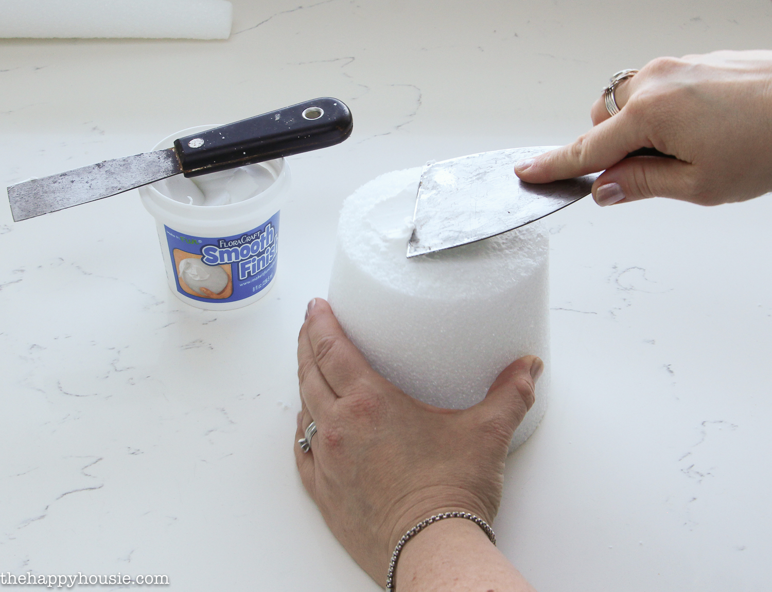 Putting smooth finish on the top of the styrofoam.