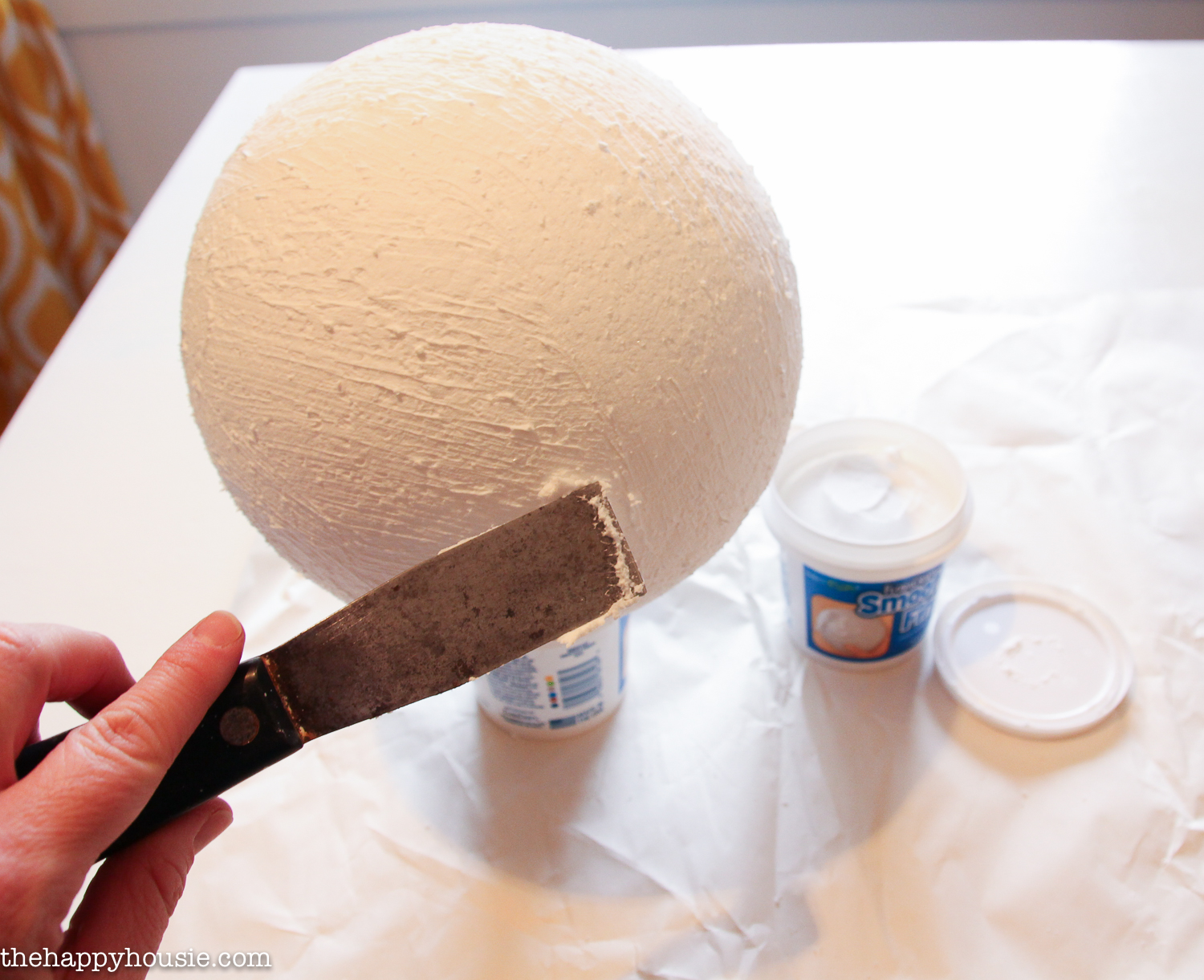 Smoothing smooth finish onto the foam ball.