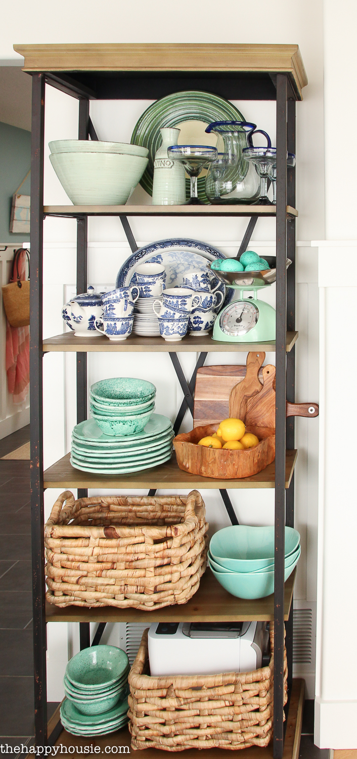 Blue and white plus turquoise dishes on the shelf.