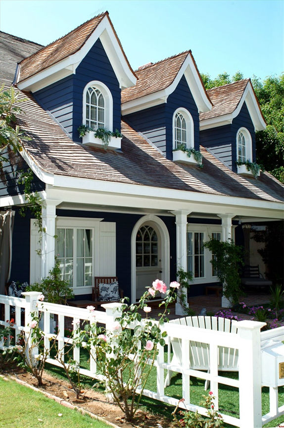 Navy blue house with window boxes and white trim.