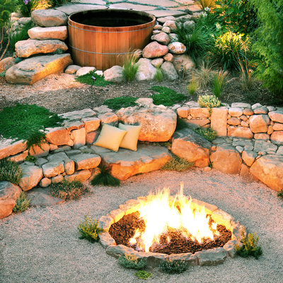 A small fire pit area on the ground with rocks around it.