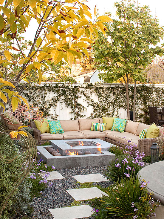 A oczy nook in a backyard with stepping stones to the fire pit.