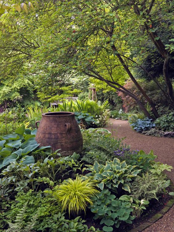 A large decorative urn in the middle of the path garden.