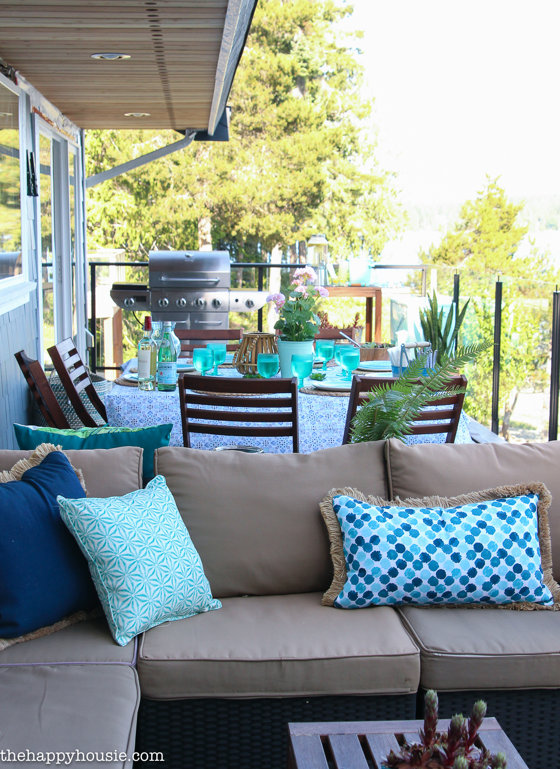 A look at the patio with the pillows and table set for a meal.