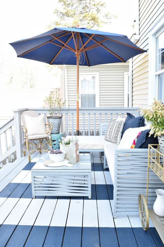 A wooden deck painted with stripes of blue and white.