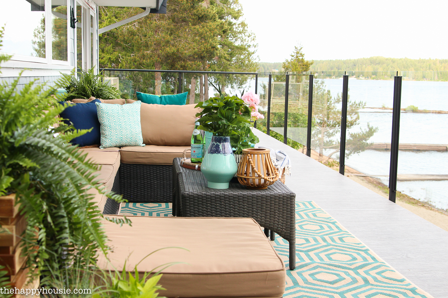 A porch overlooking the lake with an outdoor couch.