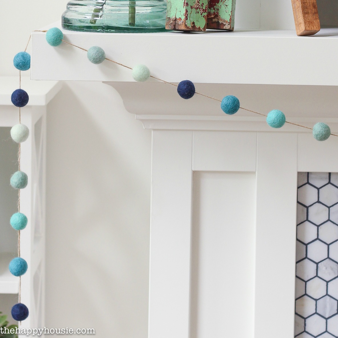 The ombre felt garland on strung up on the mantel.