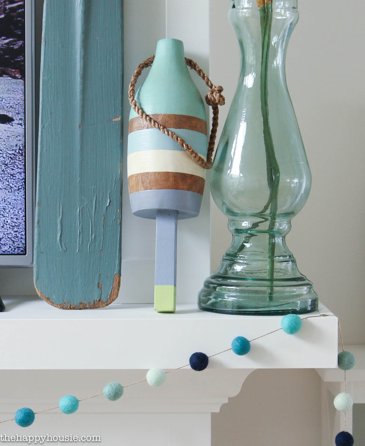 Nautical inspired items is on the mantel.