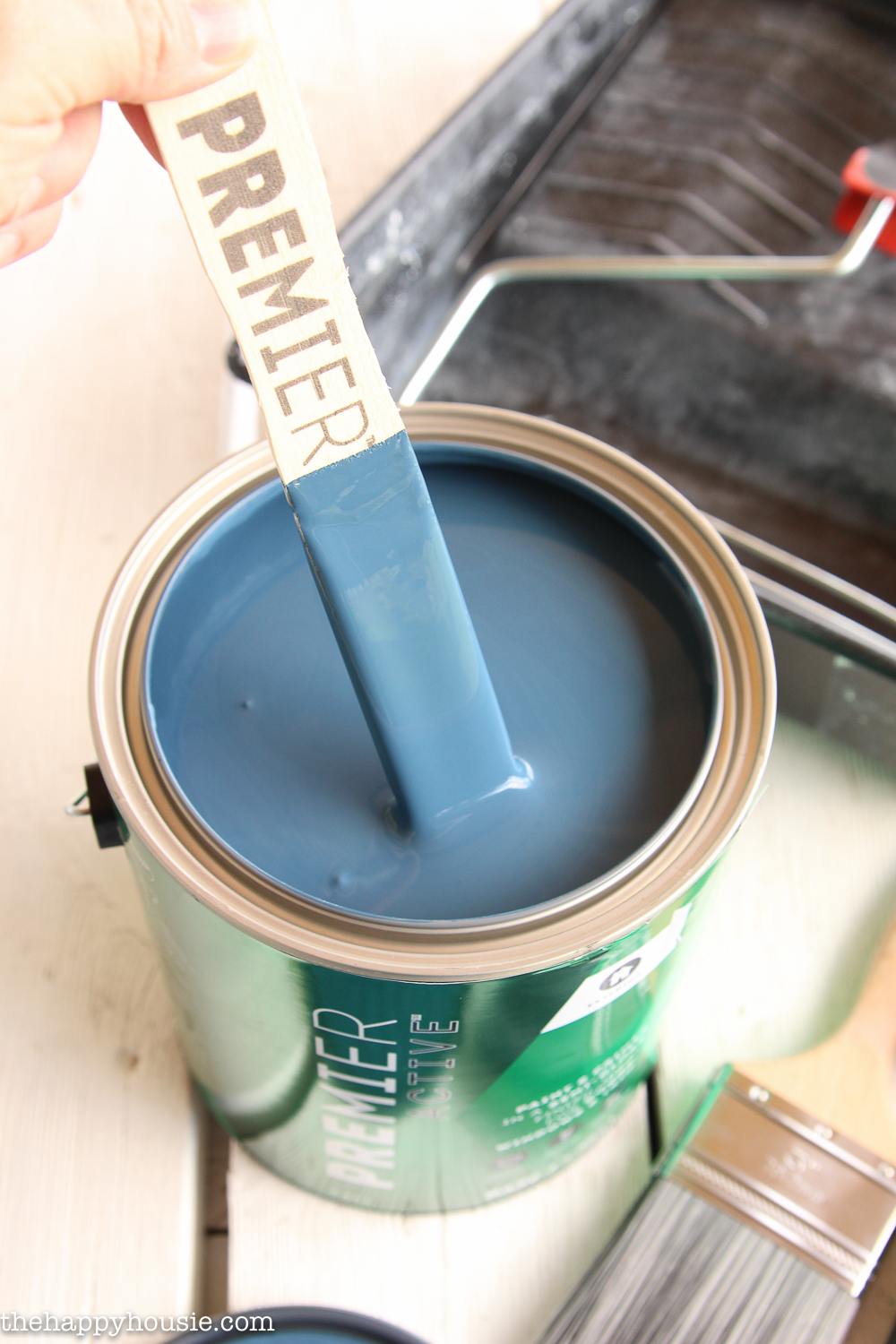 A blue/gray paint being stirred.