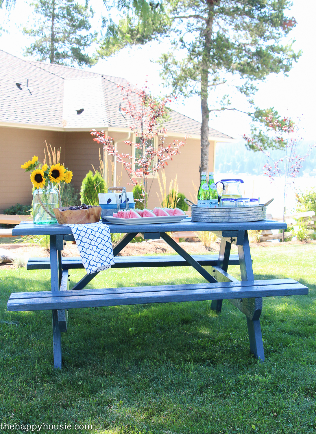 The painted picnic table with food on top of it.