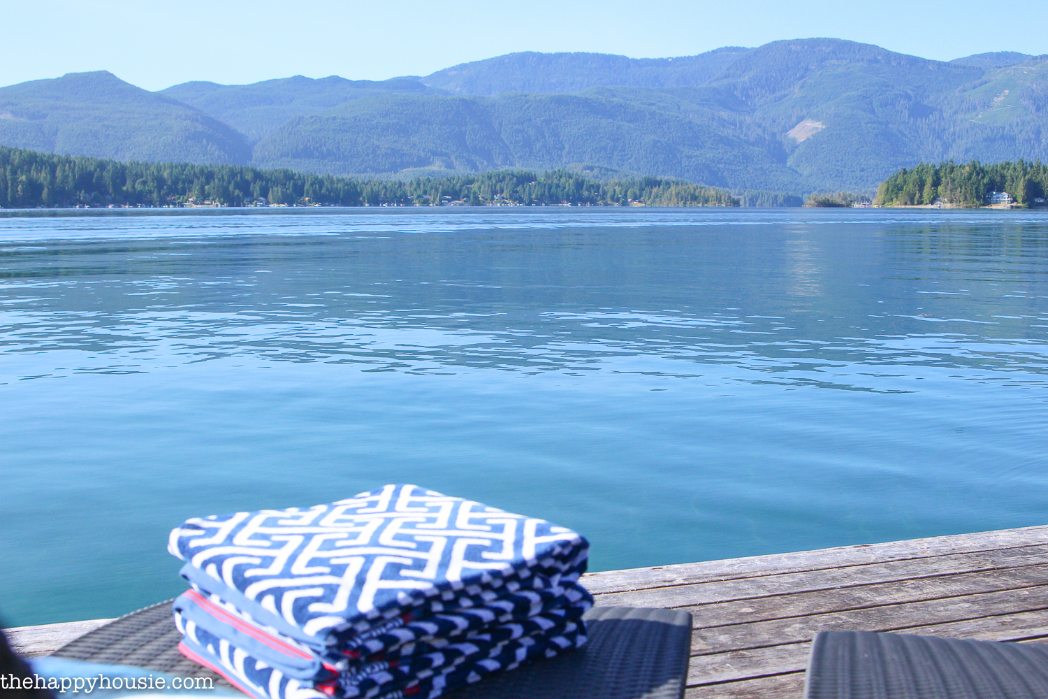 A view of the lake and a pile of towels.