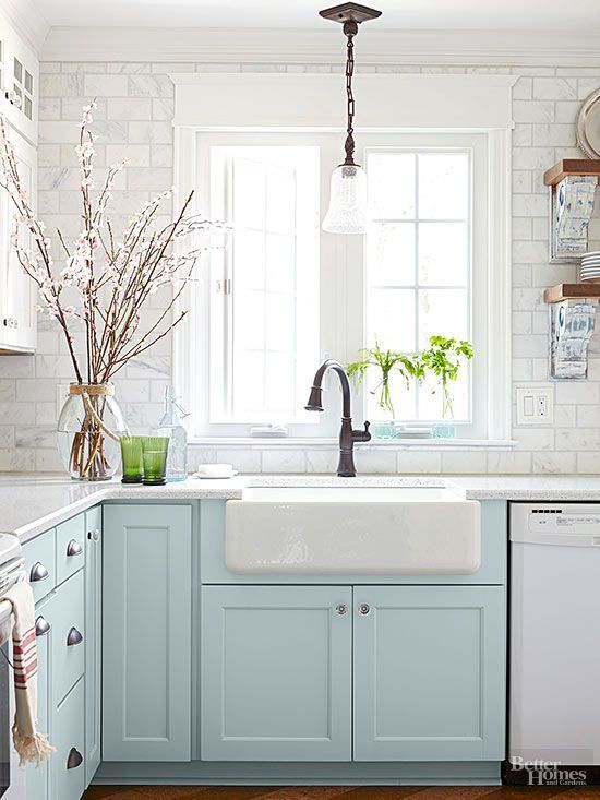 Light blue farmhouse kitchen cabinets with an apron sink.