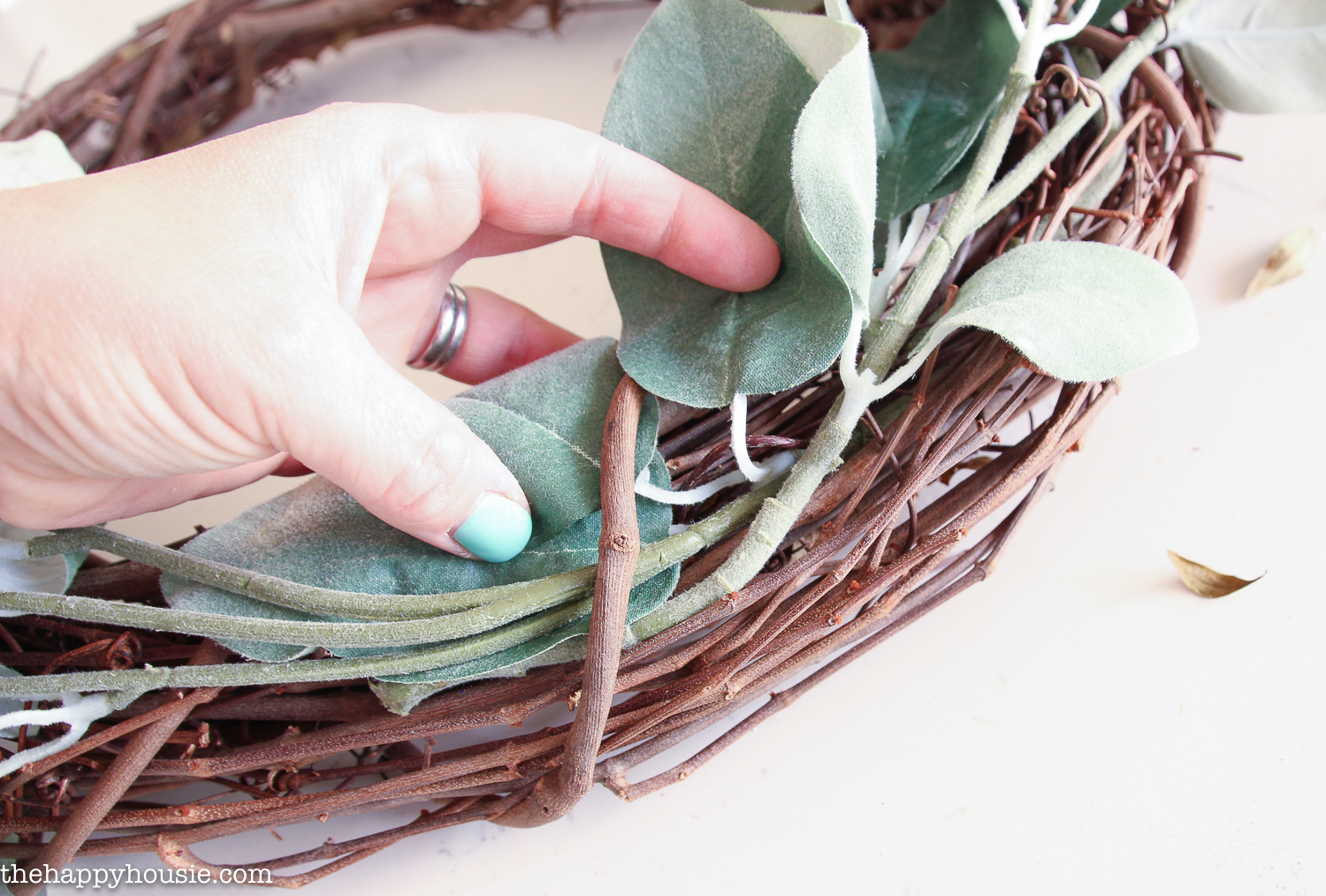 Bending the leaves and stems to fit on the wreath.