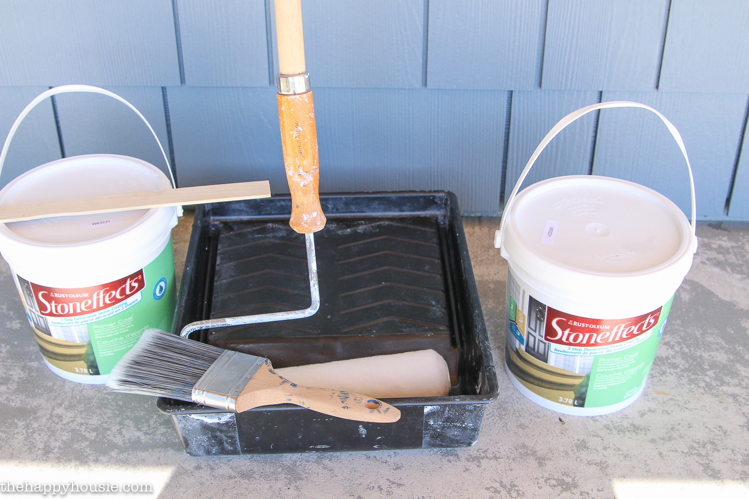 Buckets of stone effects and a paint roller.