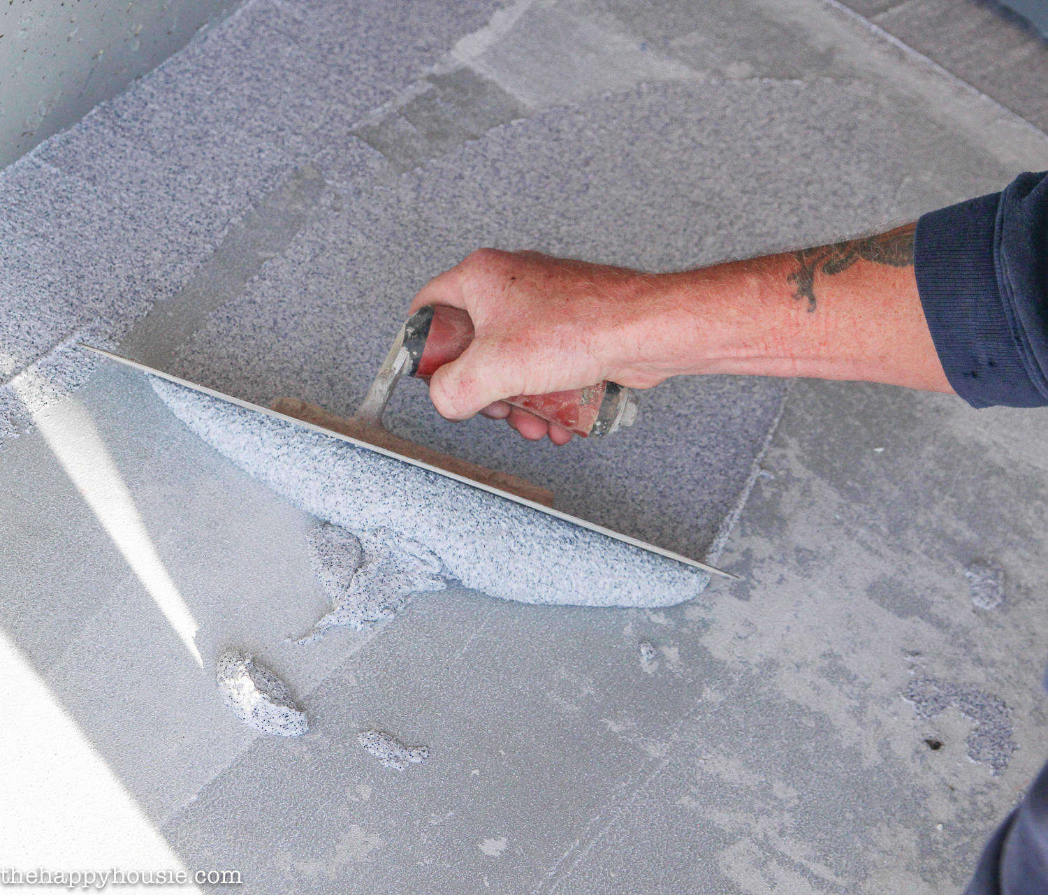 Smoothing out the stone effects with a trowel.