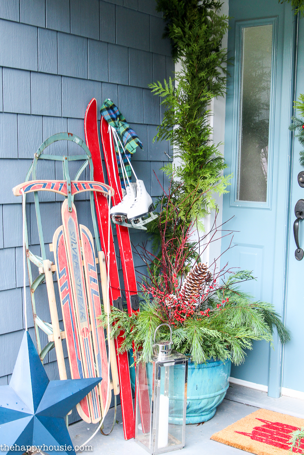 A sled, skis, and skates are all by the front door.