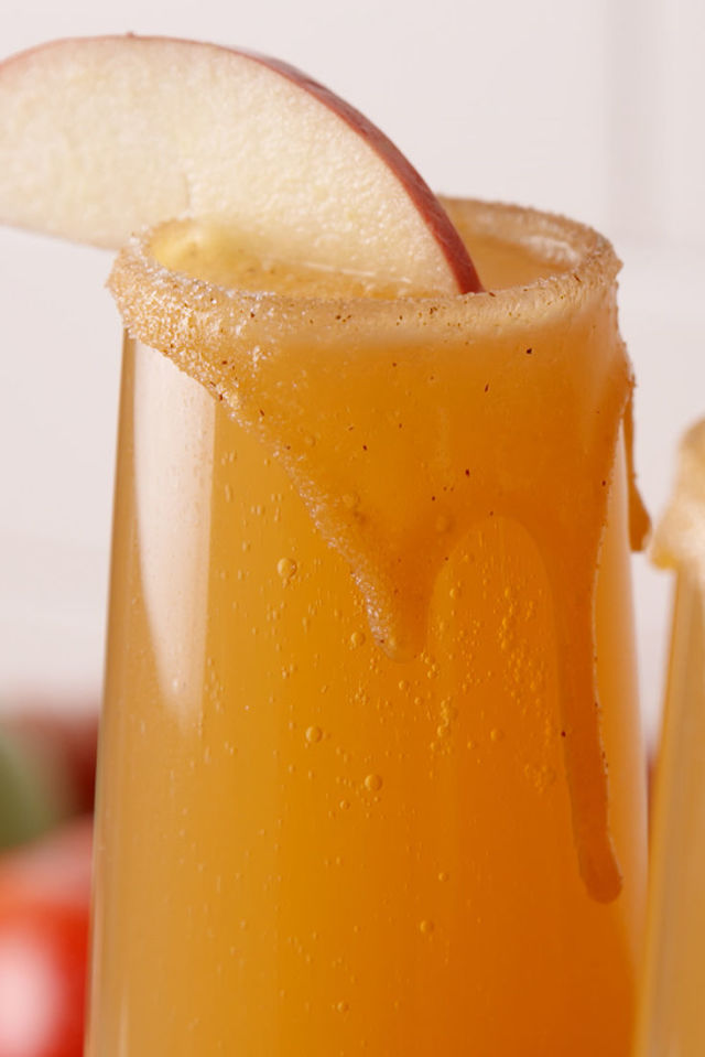 Caramel apple mimosa with an apple slice on top.