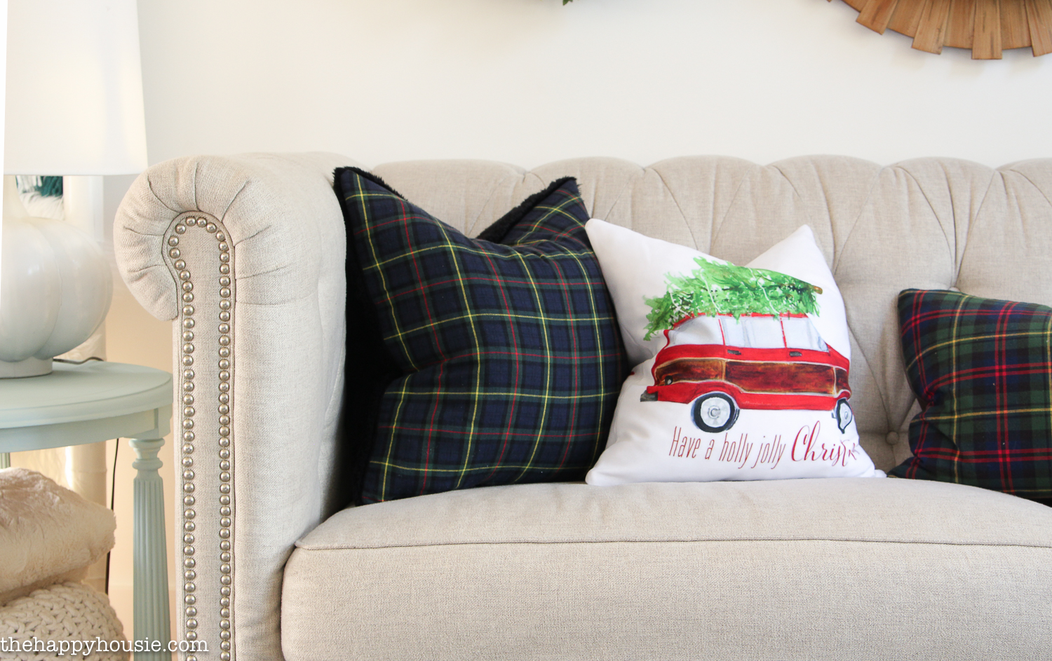 Seasonal pillows are on the couch.