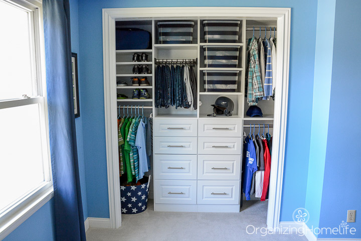 A blue room with a small closet and drawers.