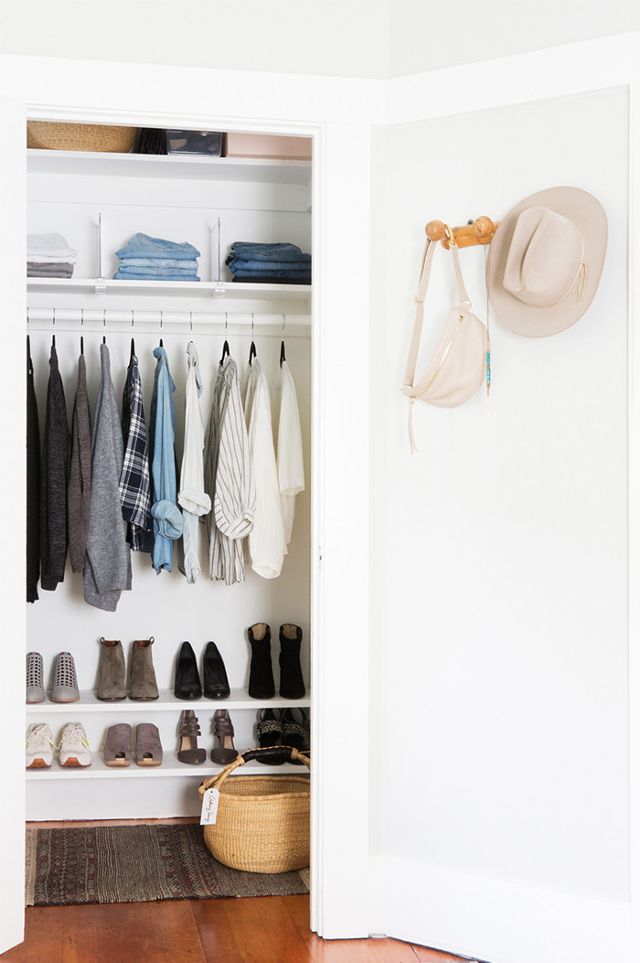 Hats are hanging on the inside of the closet.