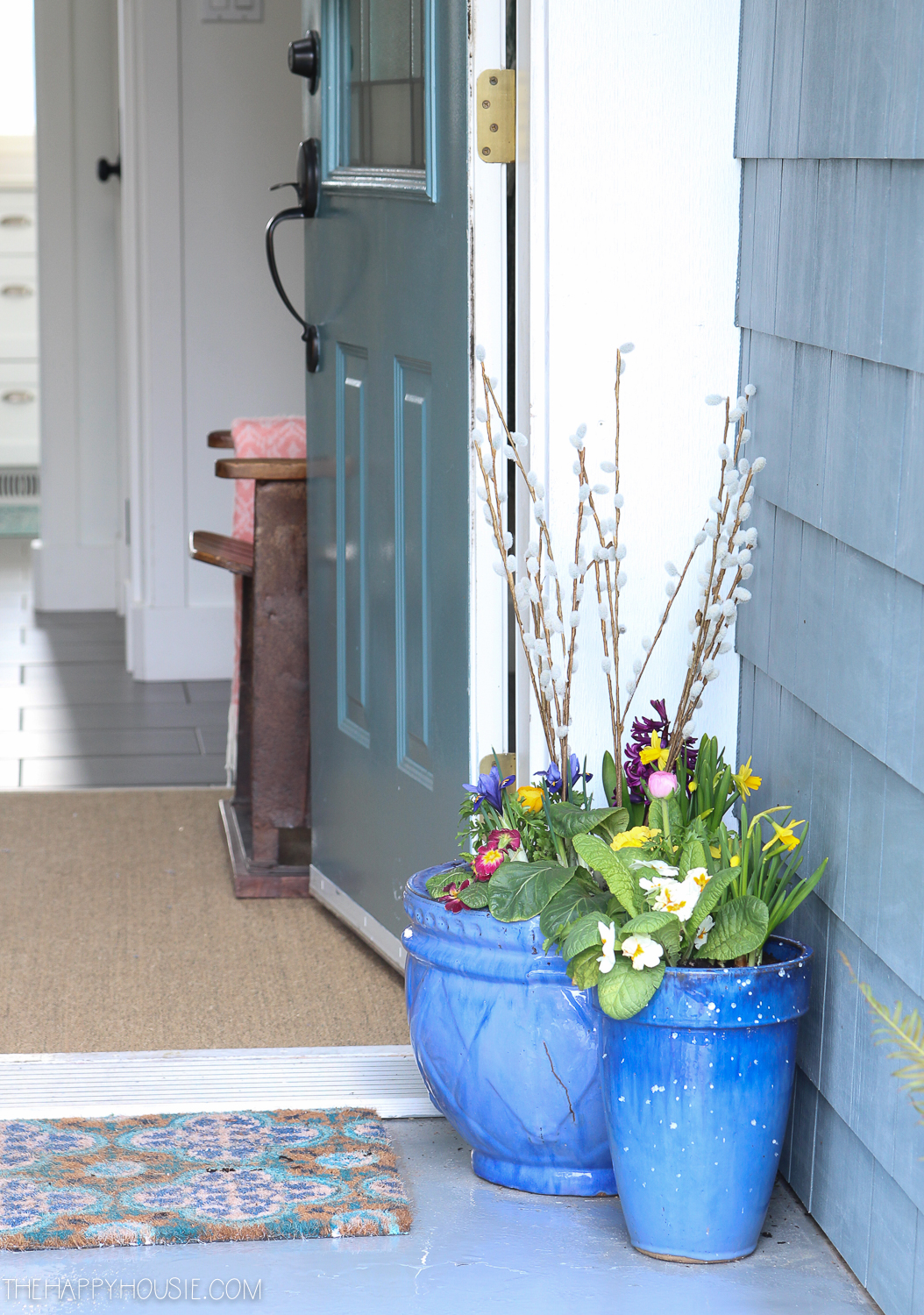 Two blue planters by the front door.
