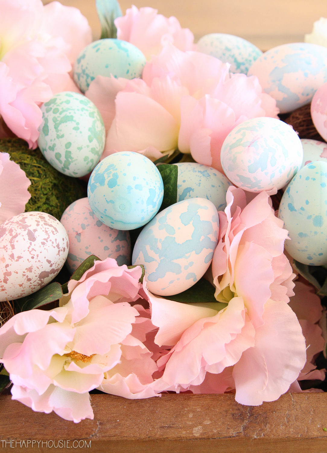Up close shot of the painted Easter eggs and pink flowers.
