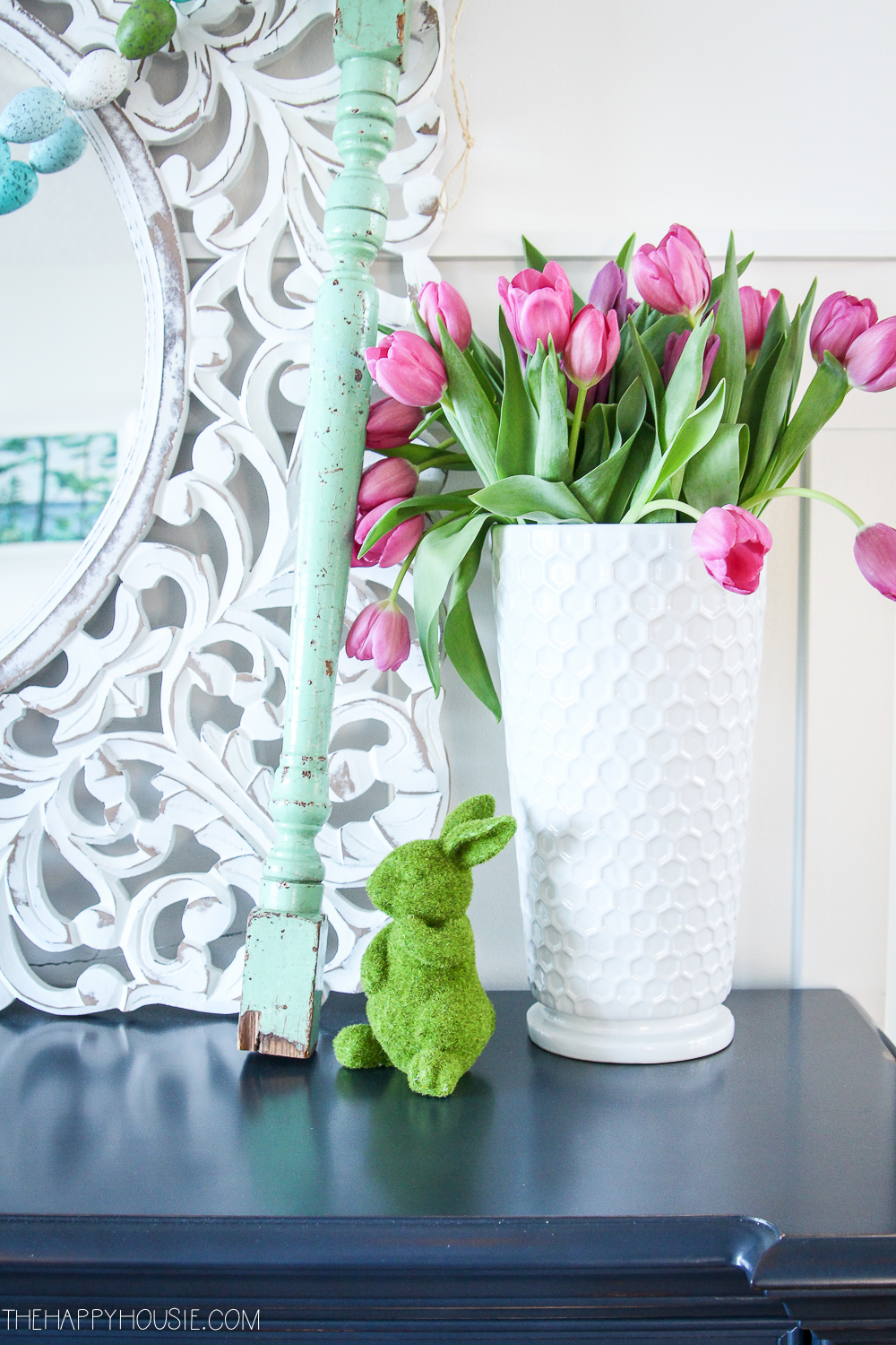 A white vase with tulips.