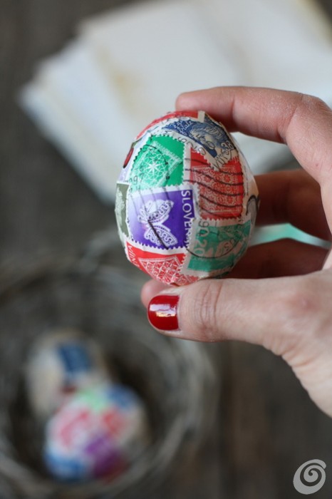 An Easter egg covered in stamps.