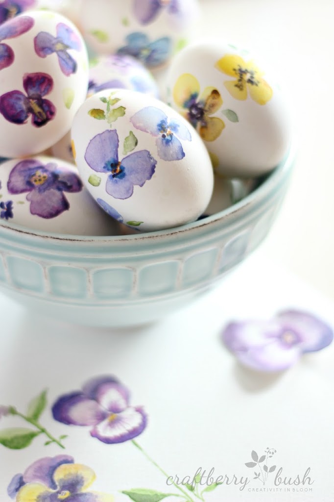 Watercolour flowers on the eggs in purples and yellows.