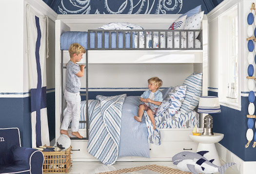 Blue and white nautical themed room with bunk beds.