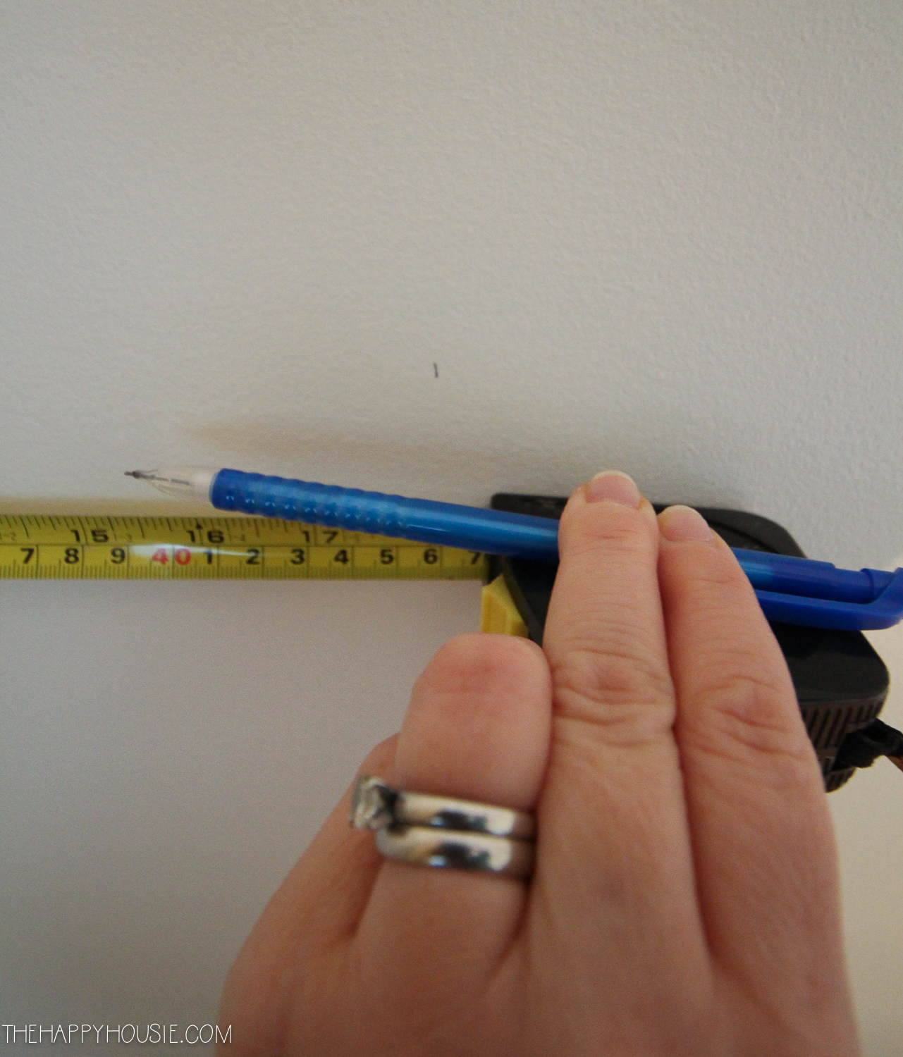 Using a tape measure and drawing a line.