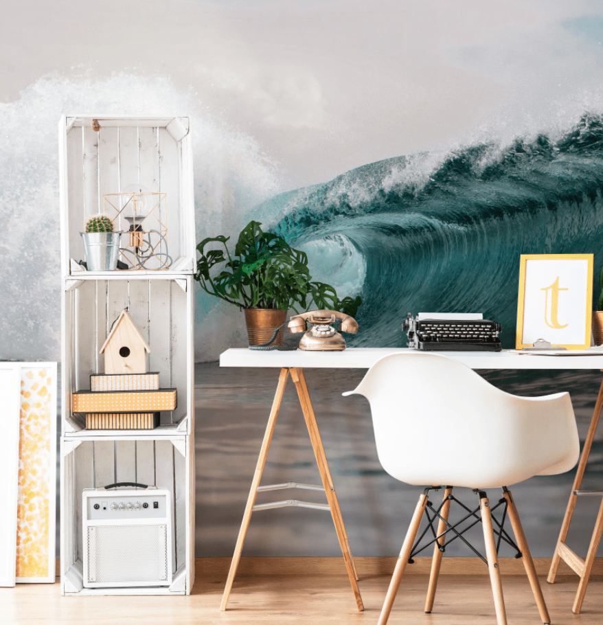 Surfing wave wallpaper behind a white desk.