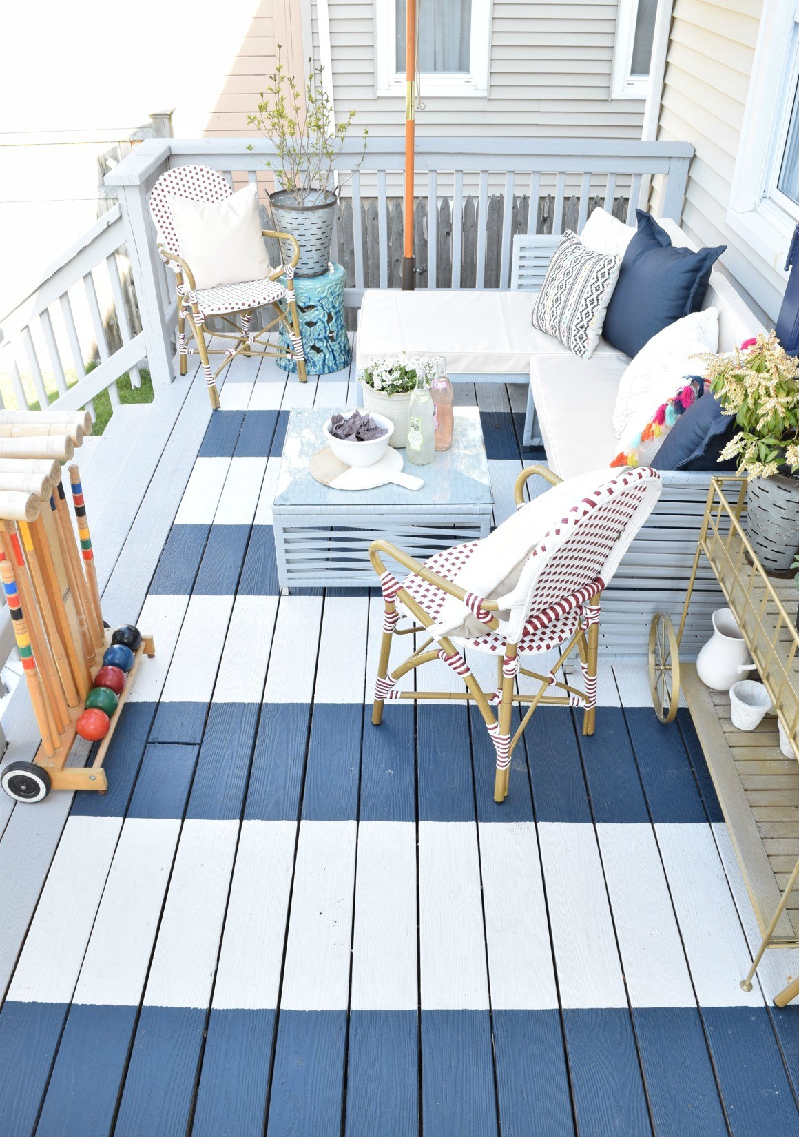 A wooden deck painted blue and white stripes.