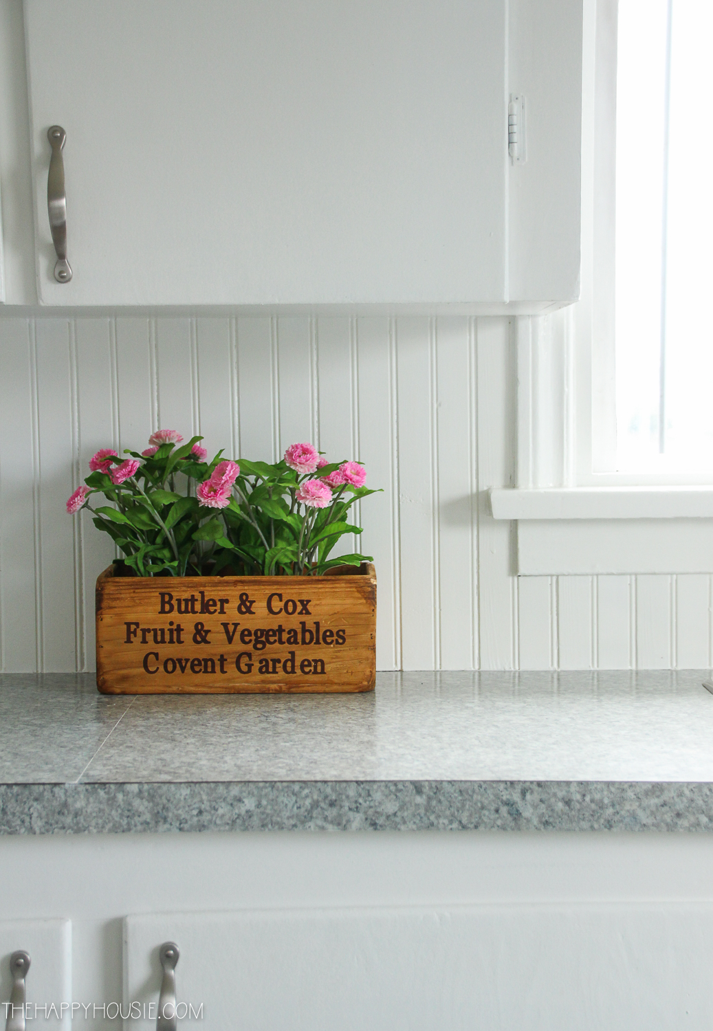 A box with pink flowers is on the counter.