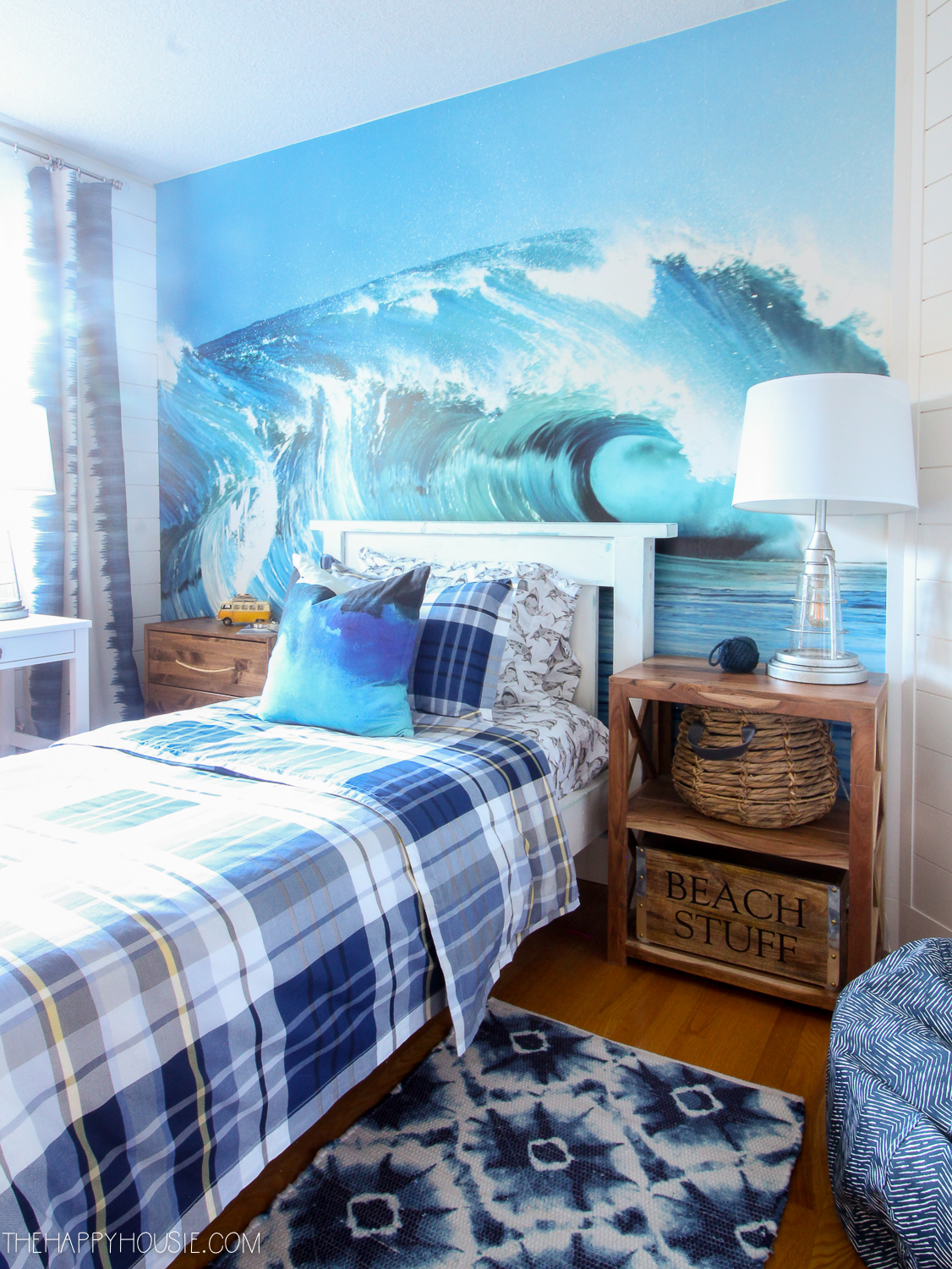 surf style boys bedroom with large wave wall mural