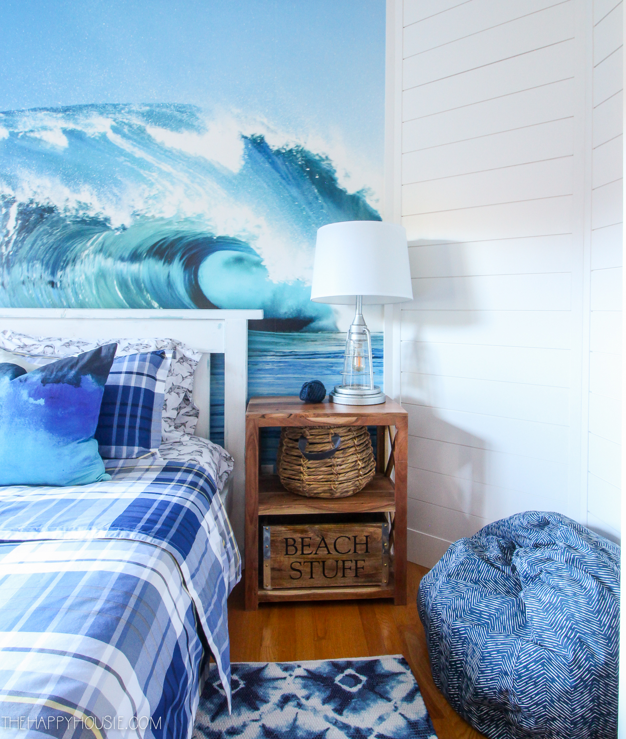 The room with a surf poster behind the bed.
