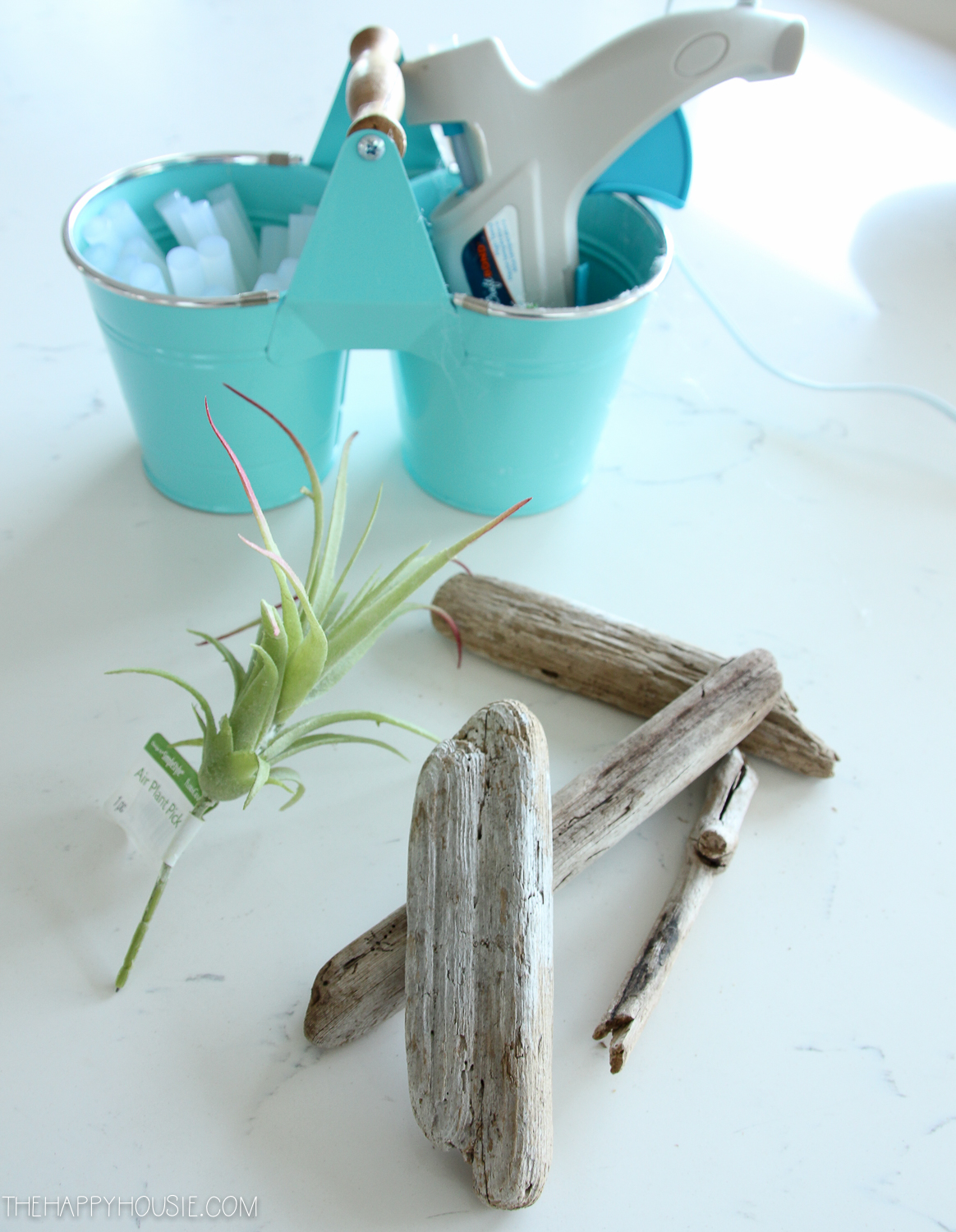The driftwood, a small plastic plant and a glue gun.