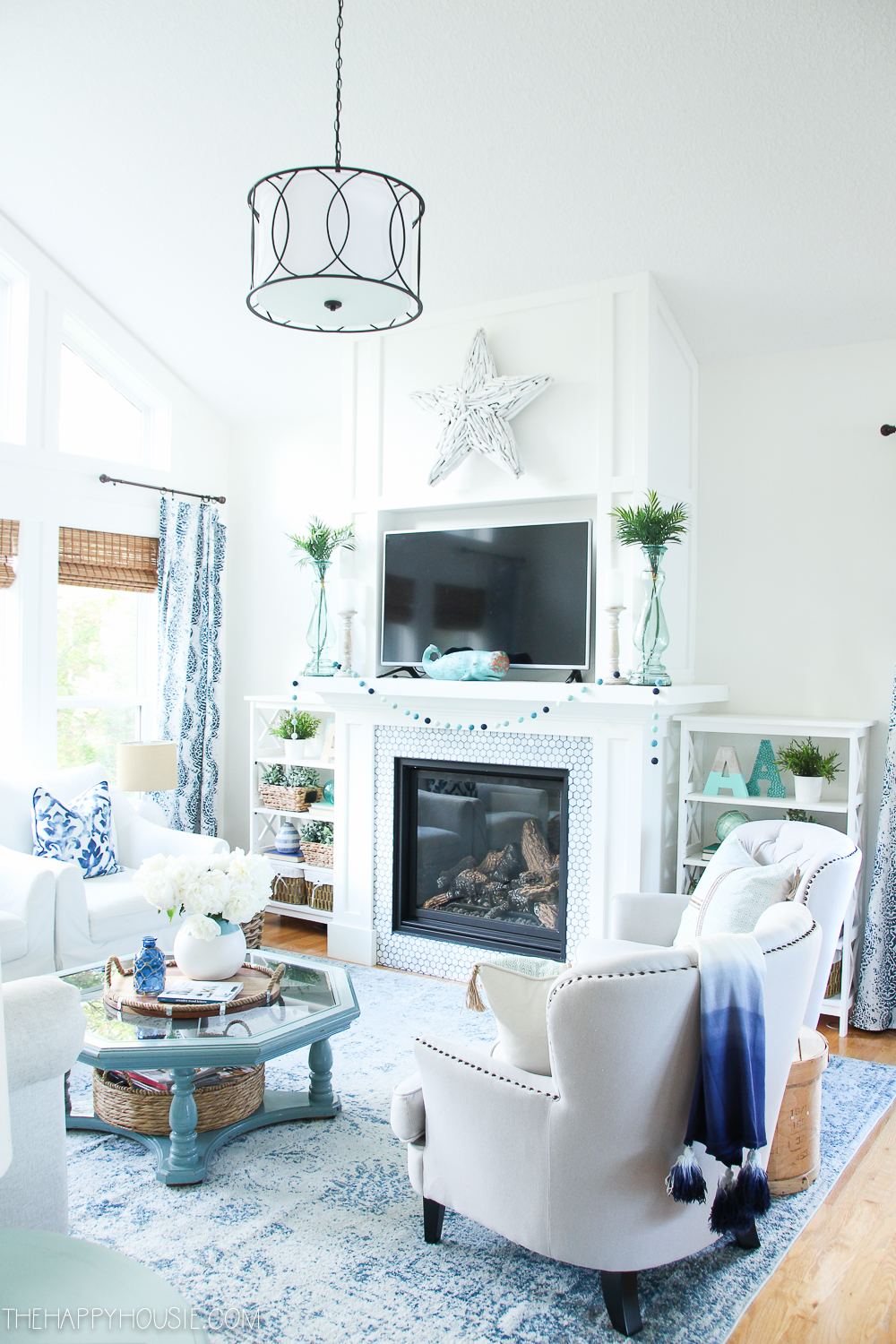 A white fireplace in the living room.