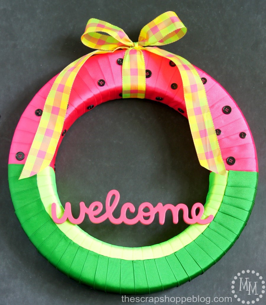 A wreath with ribbon wrapped around it to look like a watermelon.